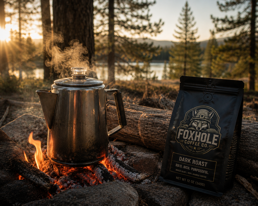Classic steel percolator on campfire coals at golden hour with Foxhole Coffee Dark Roast bag